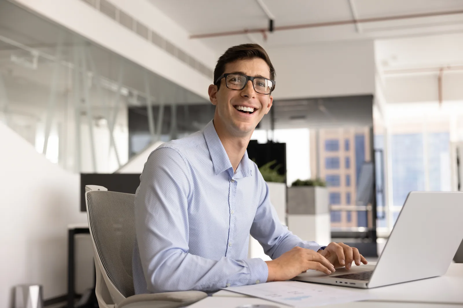 Business owner smiling while working at a laptop